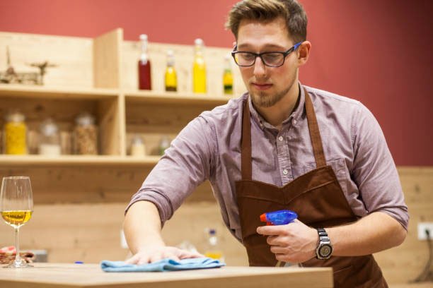 green products for coffee bars image of man using green cleaning products aroma coffee services
